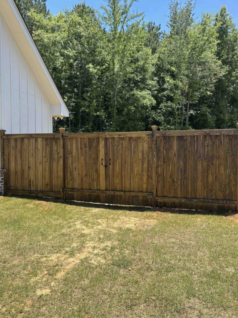 Custom gated fence built by Longleaf Building Company